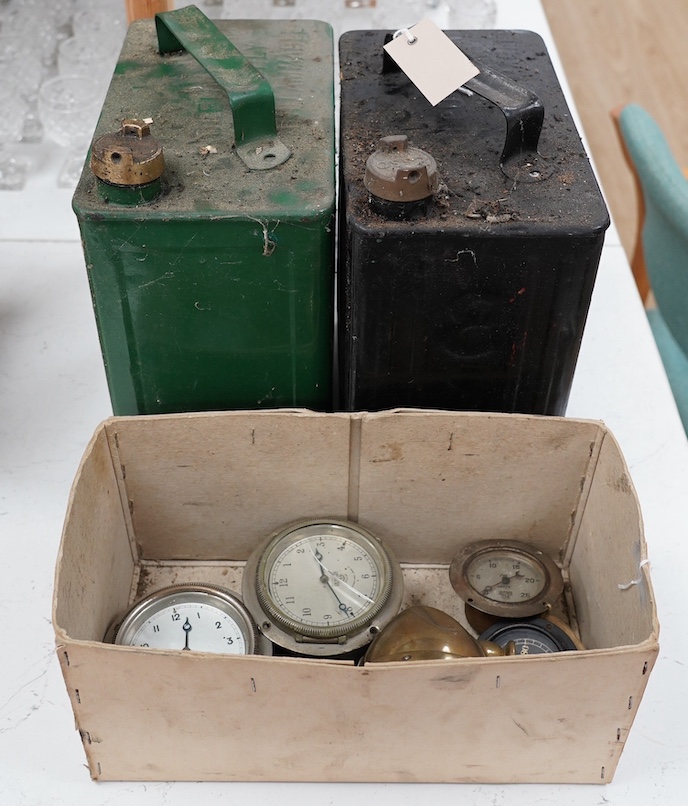 Three early Smiths car timepieces, two oil pressure gauges, a small brass headlamp and two petrol cans with brass caps, one embossed ‘Esso’ with corresponding casting on cap, the other unmarked. Condition - poor to fair